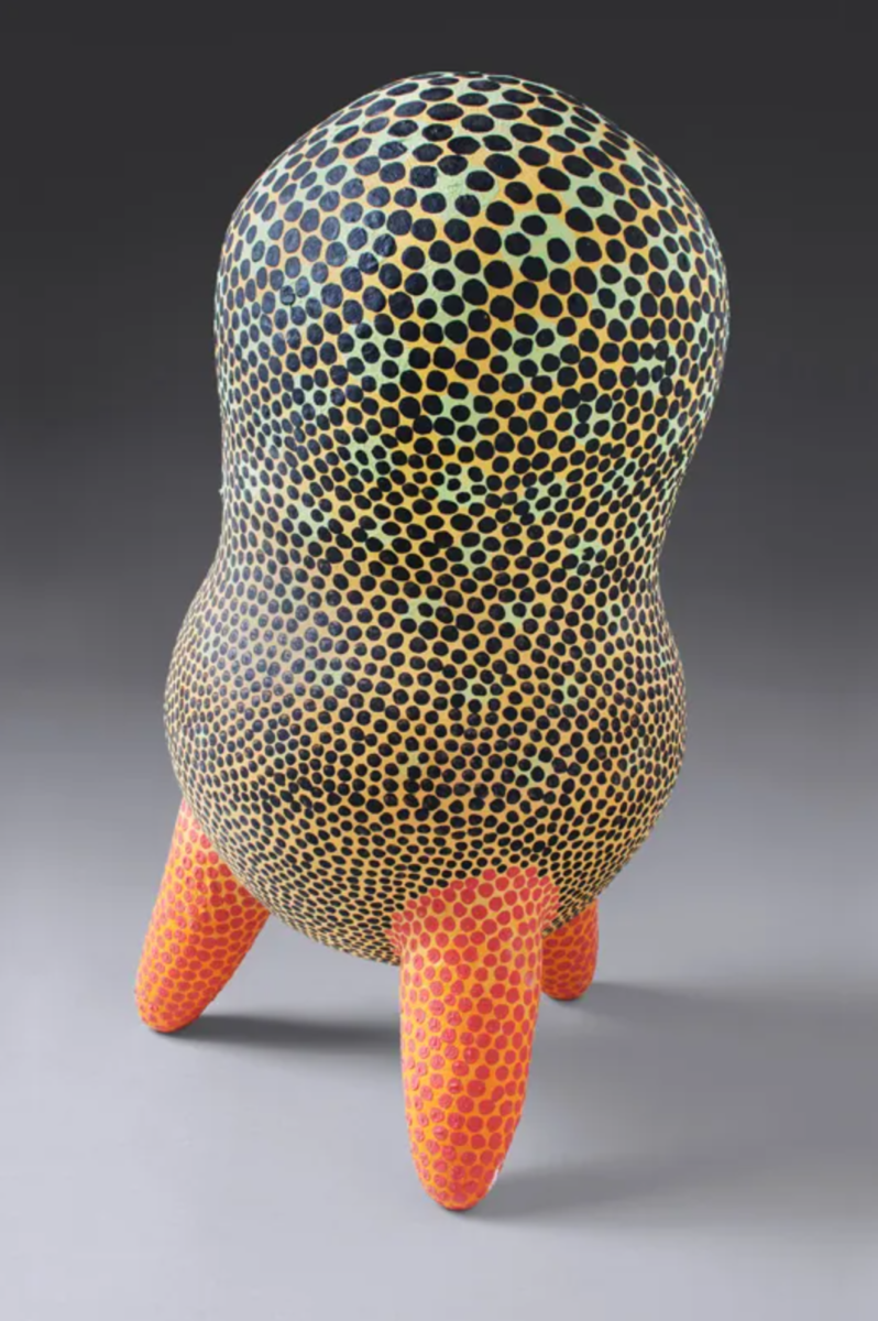 yellow and orange spotted ceramic with three legs